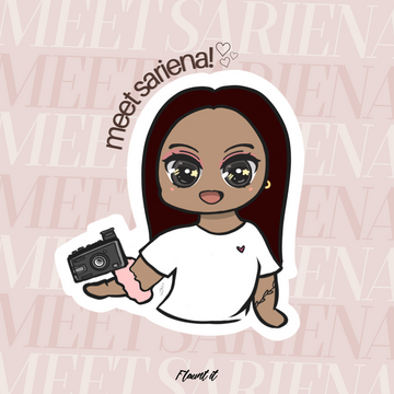 Cute drawing of a medium-skin-toned girl with dark brown hair, wearing a white shirt with a heart. On her right arm is a scrunchy, and she is holding a camera. On her left wrist is a tattoo.